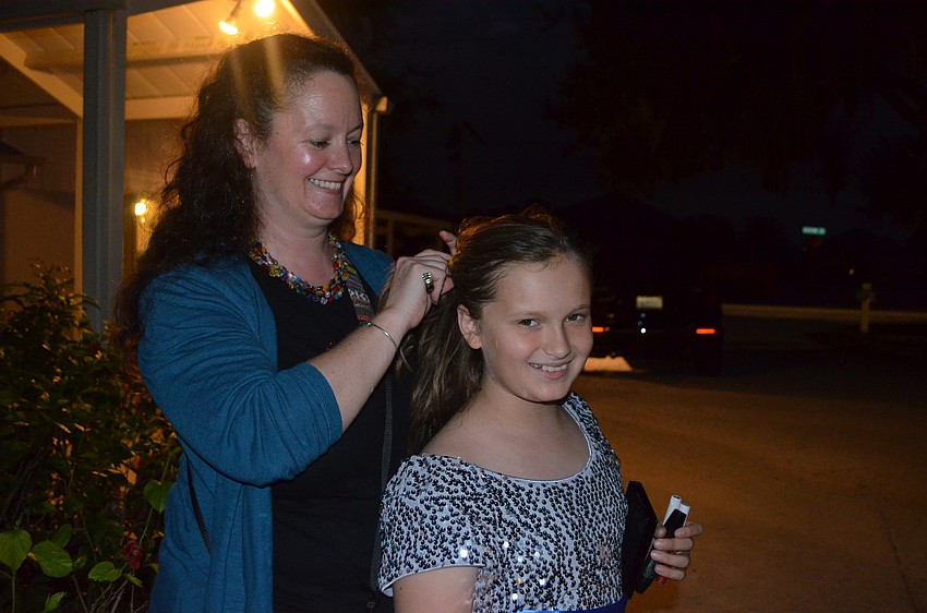 Cheryl Allen helps her daughter, Teagan, get ready.