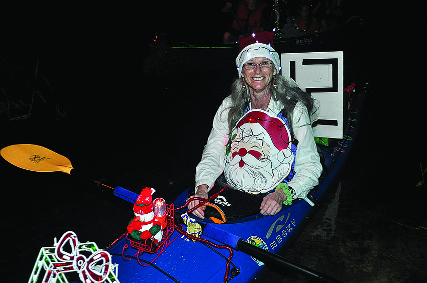 Judy Zolna participates in the Old Braden River Historical Society's first holiday boat parade Dec. 8. Spectators cheered as 18 decorated boats concluded their five-mile trek from Jigg's Landing to Linger Lodge Restaurant.