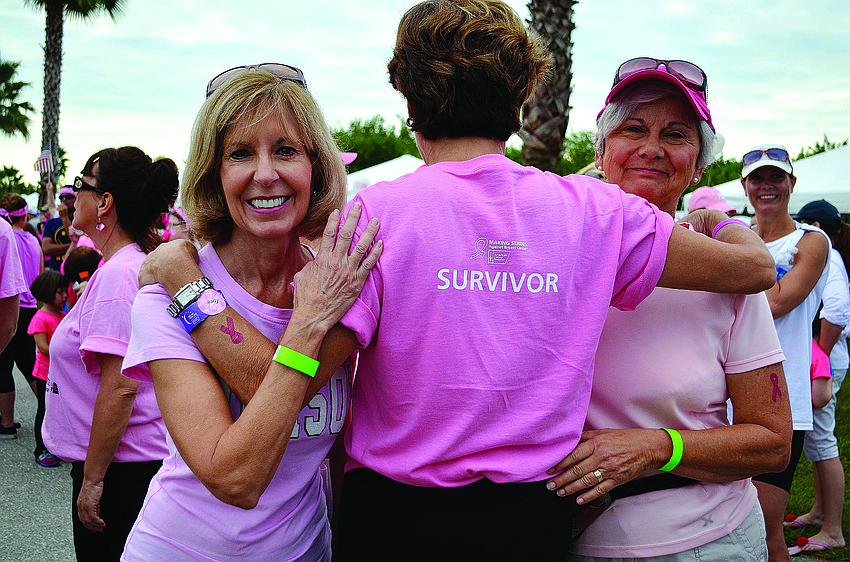 Joann Hutchinson, Charisse May and Sara Kasten walk together Oct. 19, at the Sarasota Polo Club, during the American Cancer Society's Making Strides Against Breast Cancer â€” Sarasota/Manatee walk.