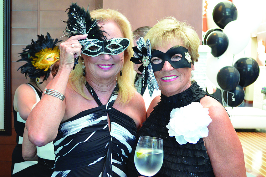 Gloria Lipscomb and Margit Gravino are feathered friends Aug. 10, at Sarasota Yacht Club's Black and White Ball.