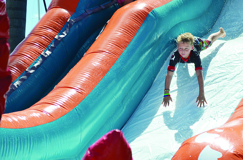 Jack Foluig catches some air on the water slide at Sarasota Yacht Club's Sept. 29 Family Fun Day.