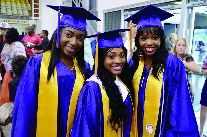 Booker High School seniors Tamera Thompson, Kay'La Riddle and Bianca Sumter join family and friends for a graduation ceremony June 1 at Robarts Arena.