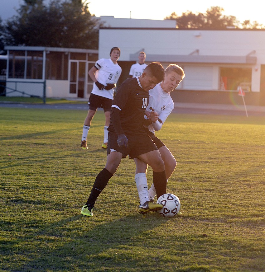 Braden River midfielder Hector Perez and Lakewood Ranch midfielder Jake Dube battle for possession in the first half.