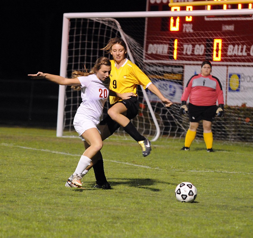 Cardinal Mooneyâ€™s Courtney Lynn and Booker Highâ€™s Joy Jux battle for possession during the first half of their Class 2A-District 11 semifinal match Jan. 14.