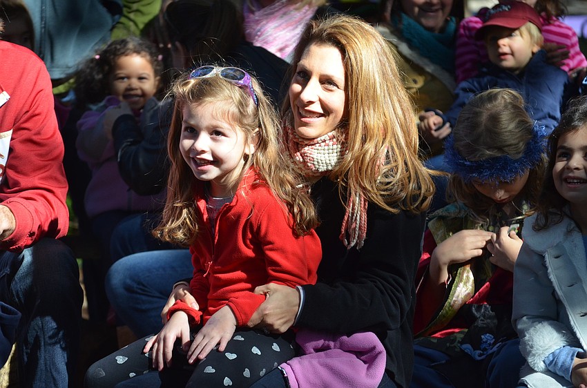 Alicia Zoller and Emma Zoller sing along with Rabbi Glickman.
