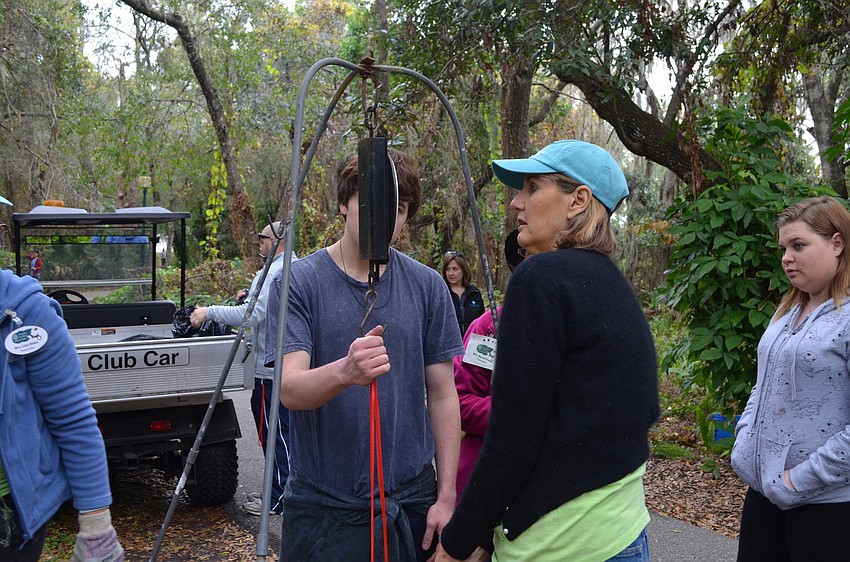 Mary Foster helps weigh a bag of potatoes.