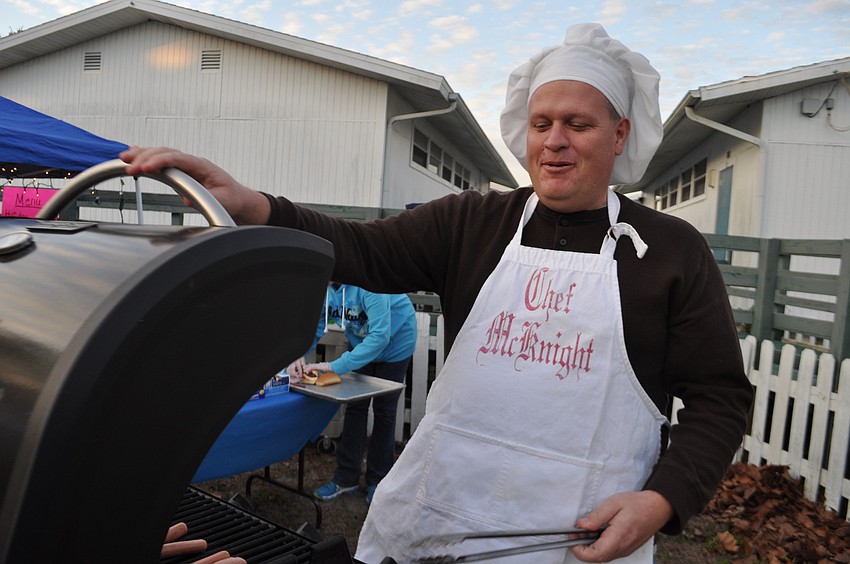 Principal Steve Royce cooks hot dogs for guests.