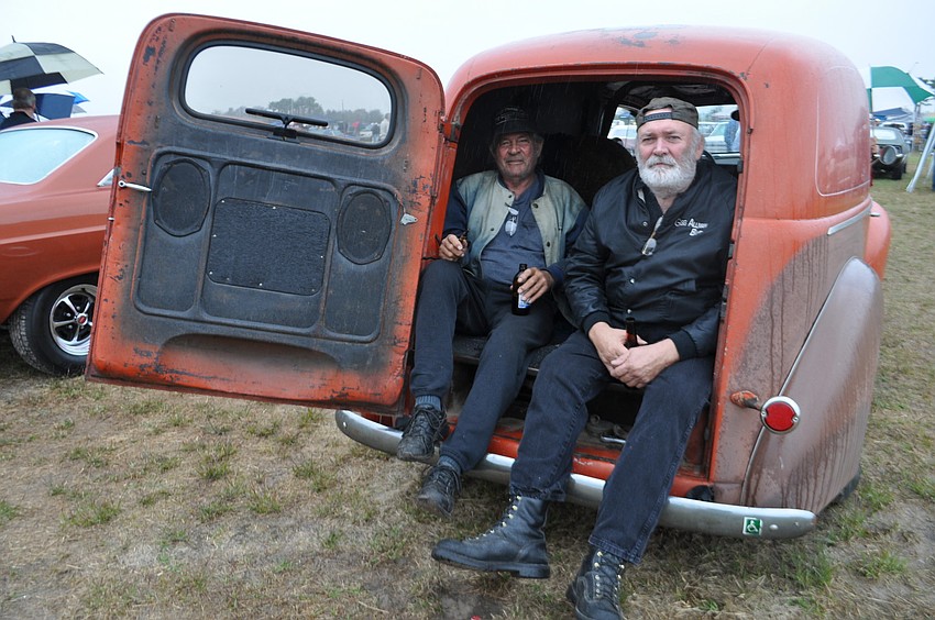 Jerry Getch  sits in the back of his 1940 Ford Sedan Delivery with friend, Tom Steele.