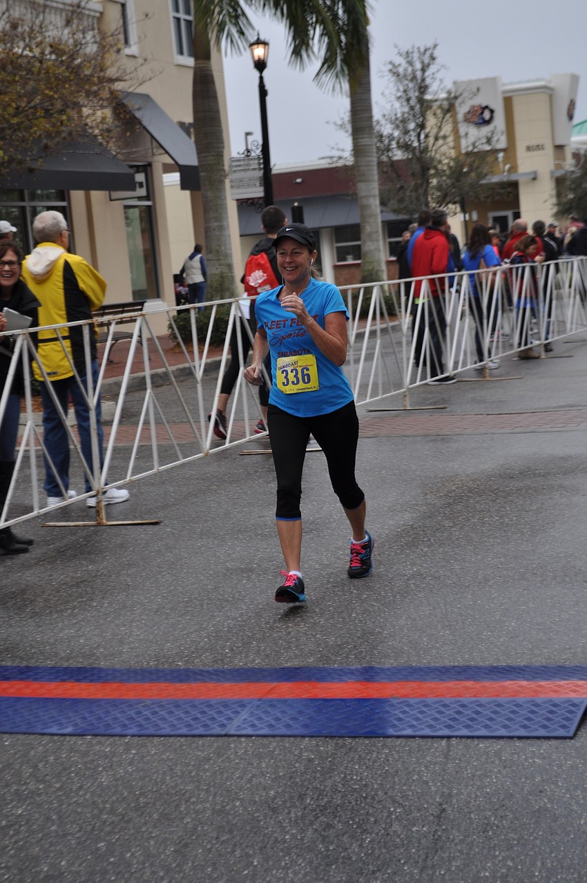Debbie Gates crosses the finish line with ease.