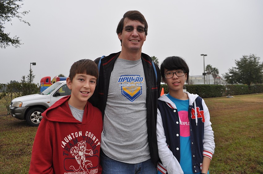 Kyle and Jeremy Evans, with exchange student Jacquelyn Chen, watch for Caeron Evans, 15.