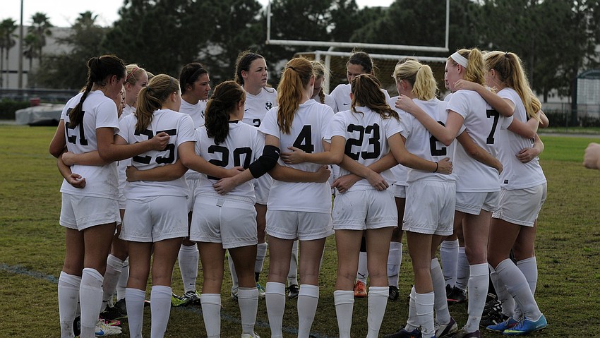 The Lakewood Ranch High girls soccer team huddles together during a water break in the second half.