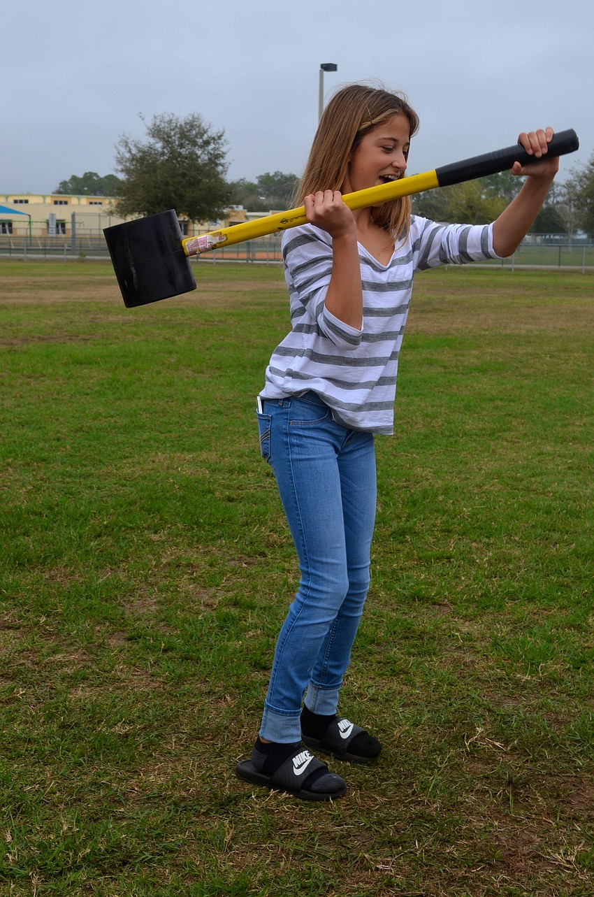 Lia Saputo, 13, shows off her strength.