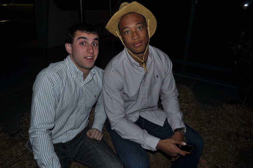Justin Otis and Chris Pearcey watch their dates dance.
