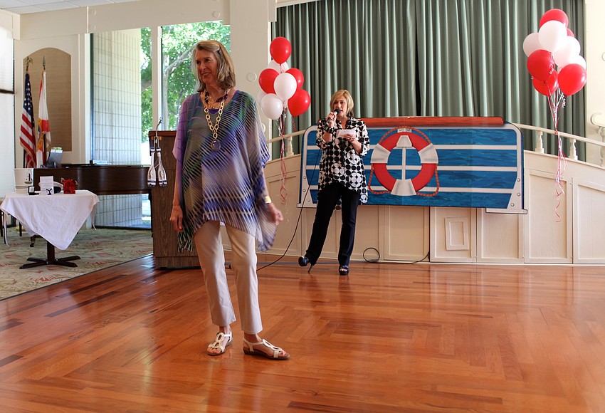 Mary Kimura poses around the stage as Karri Slezak, District Manager at Chicoâ€™s, tells the crowd about her outfit.