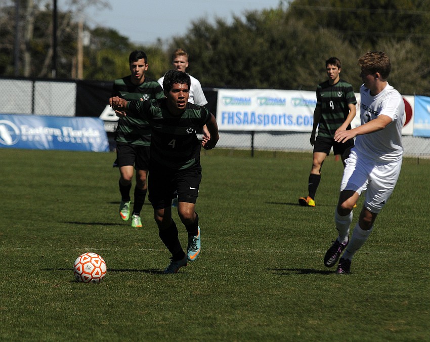 Lakewood Ranch senior midfielder Martin Martinez pushes the ball up the field for the Mustangs.