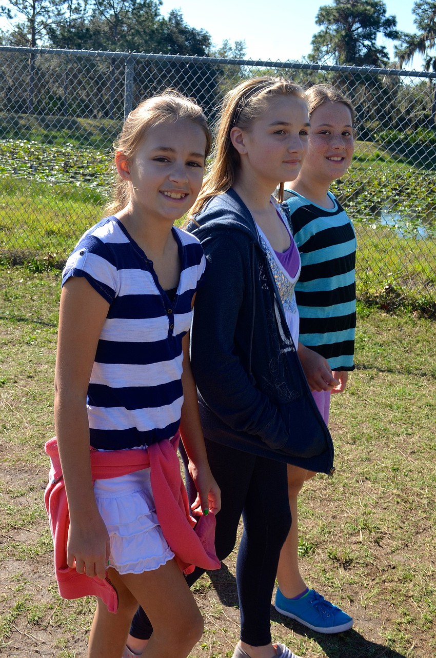 Ali Tarnowski, 11, Tabytha Siefke, 11, and Gigi Dement, 11, chat while walking.