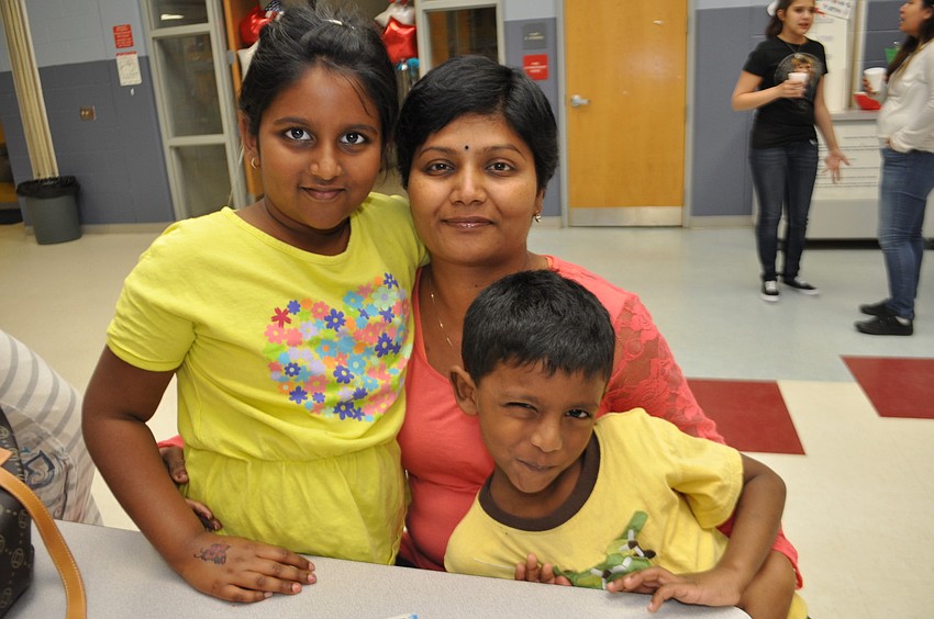 Sheena, Madhu and Chaitu Kurakula play bingo.