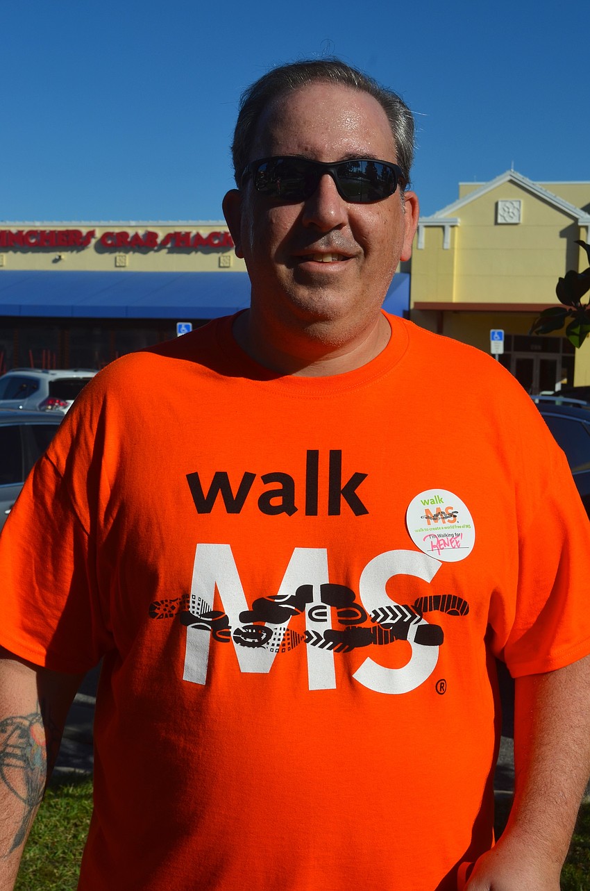Brian Leach sports an orange T-shirt.
