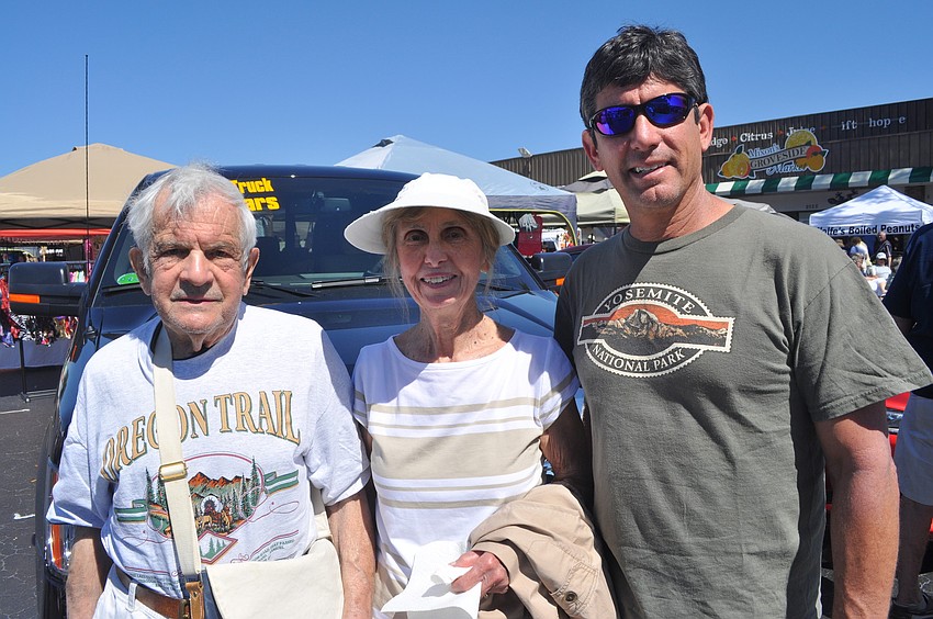 Raymond and Shirley Elish, who are visiting from Ohio, and their son, Ray, visiting from South Carolina, looked at classic cars.