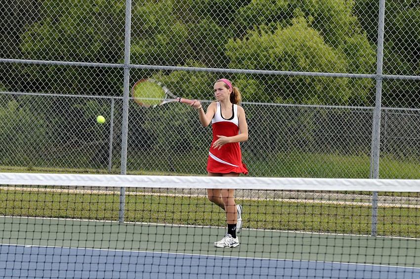 Cardinal Mooney freshman Regina Sandberg sends the ball back over the net.