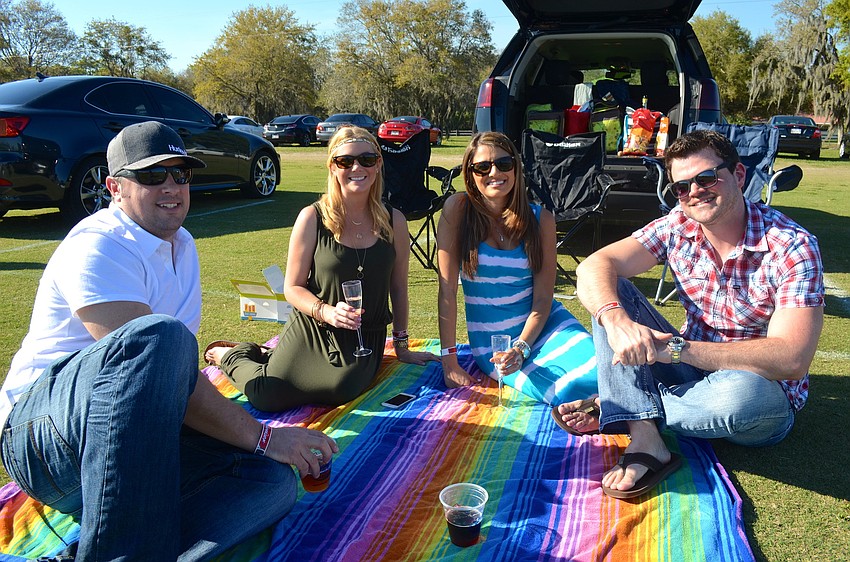 Adrian Fordham, Brittany Byrd, and Kate and Shea Tully watch the polo match from the sidelines.