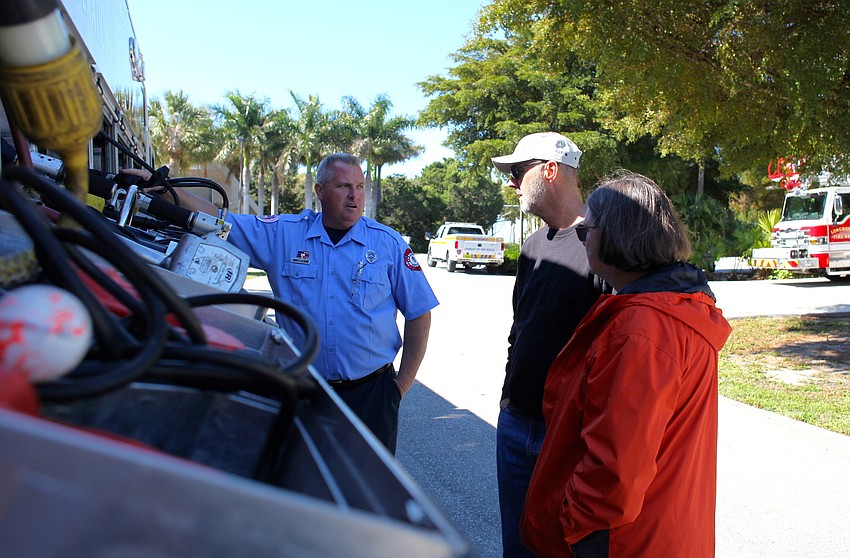 Fran Taaffe speaks to Dave and Donna Bullock about the fire truck and how it operates.