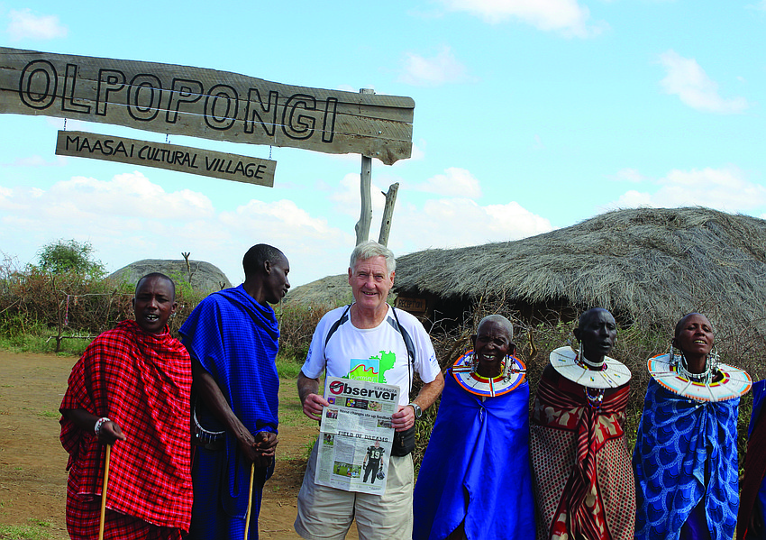 John Wallace reads the Sarasota Observer to members of a Maasai tribe in the Maasai village of Olpopongi, Tanzania. Wallace visited Tanzania to run the Kilimanjaro Marathon â€” his 370th marathon in his 120th country â€” a new world record!