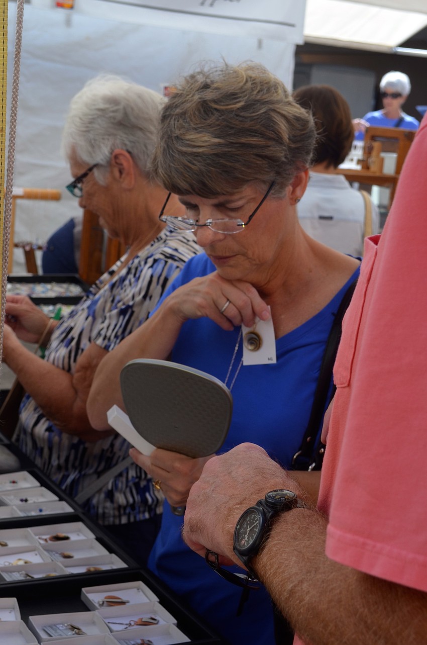 Leslie Gilman decides how much she likes a necklace.