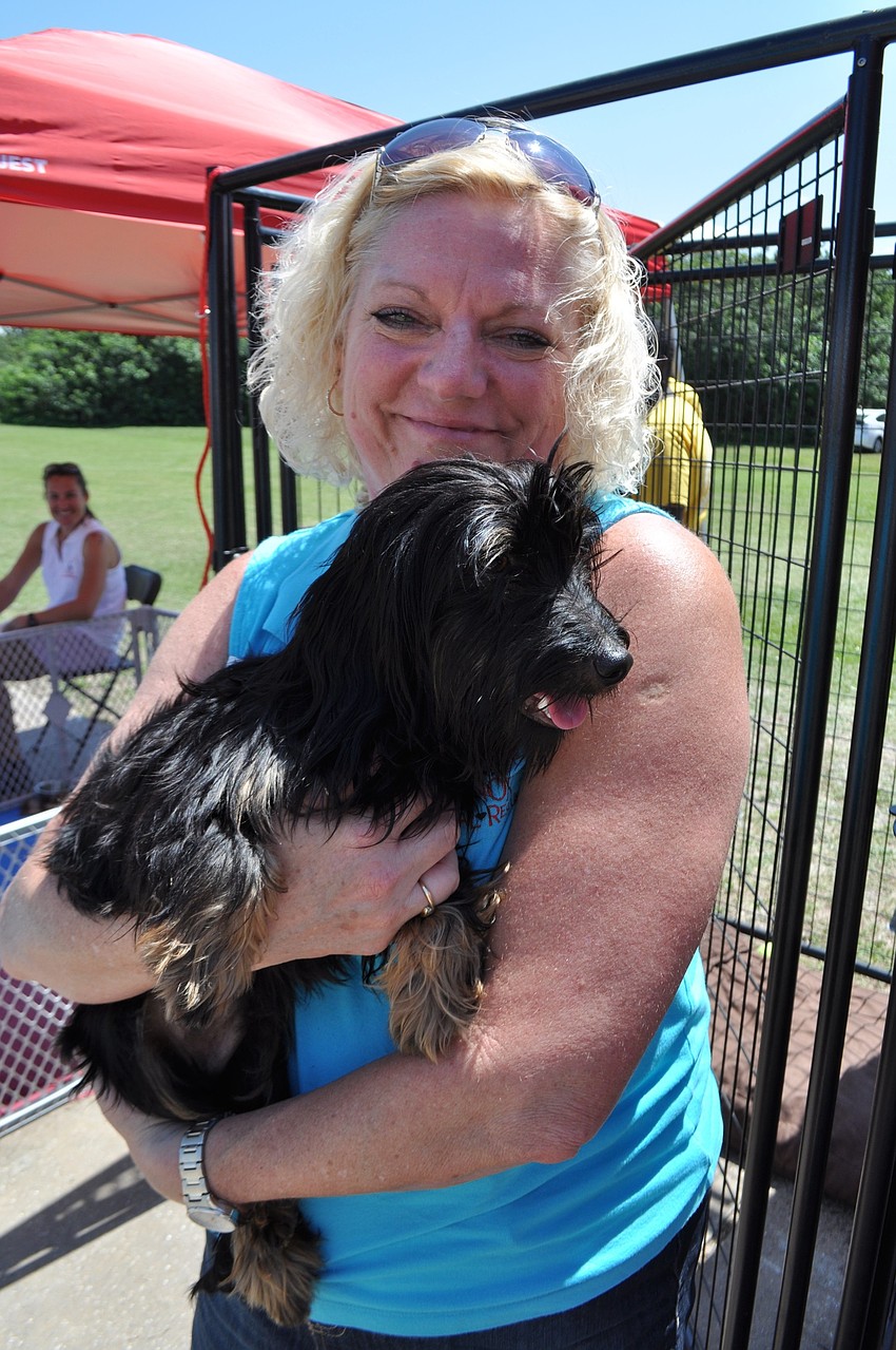 olunteer Cheryl Rice holds Drake, who was available for adoption at the event.