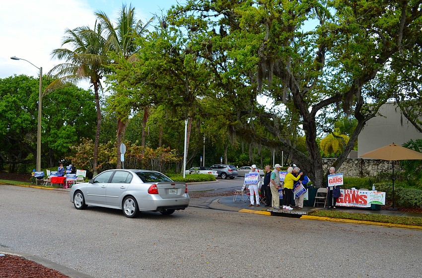 Candidates campaign outside Town Hall as residents cast their votes