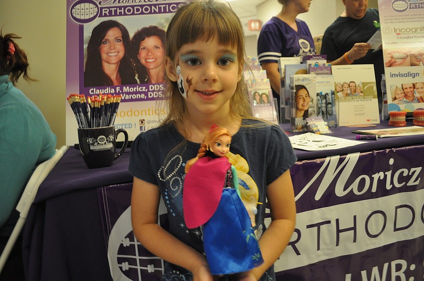 Liz Bentze, 5, checked out the Moricz and Varone Orthodontics table.