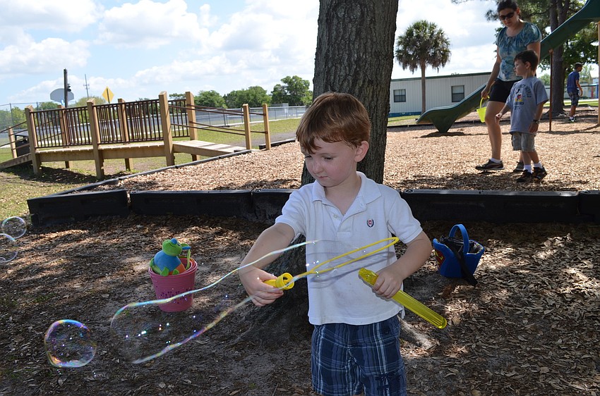 Cody Brady plays with bubbles.