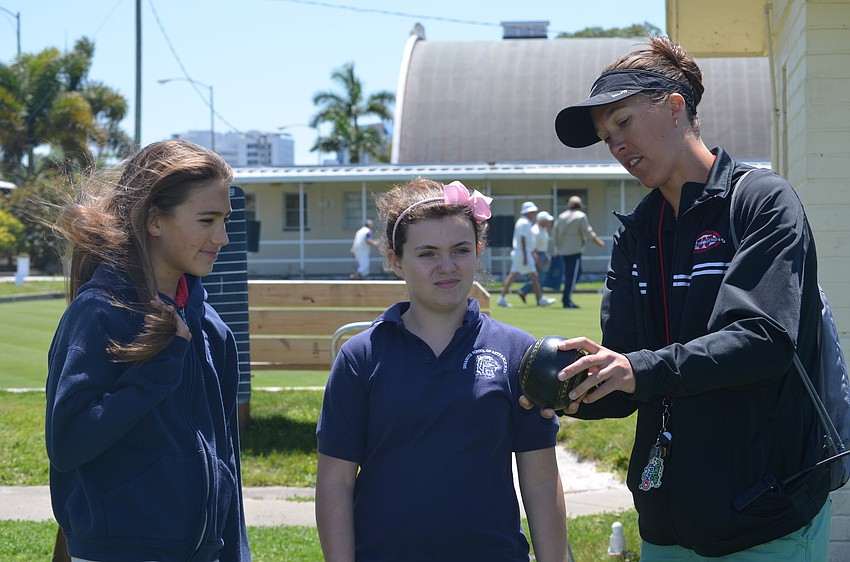 Ashlyn Downey-Hayes and Taylor Josef get tips from Coach Hollie Nelsen.