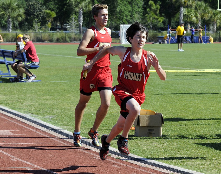 Cardinal Mooneyâ€™s Adam Sage takes off in the boys 4x800-meter relay after receiving the exchange from Mitch Gannon.