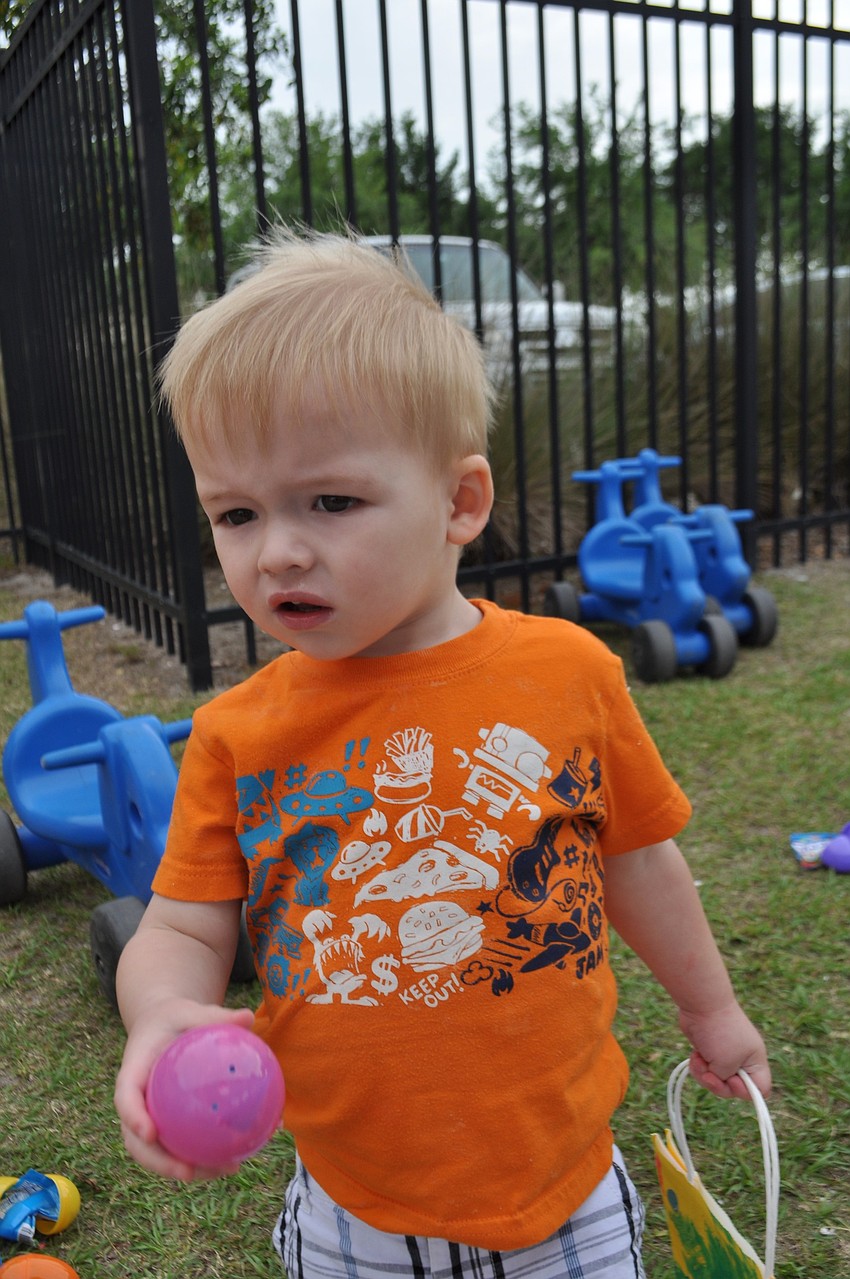 Dylan Reed, 1, finds his first egg.