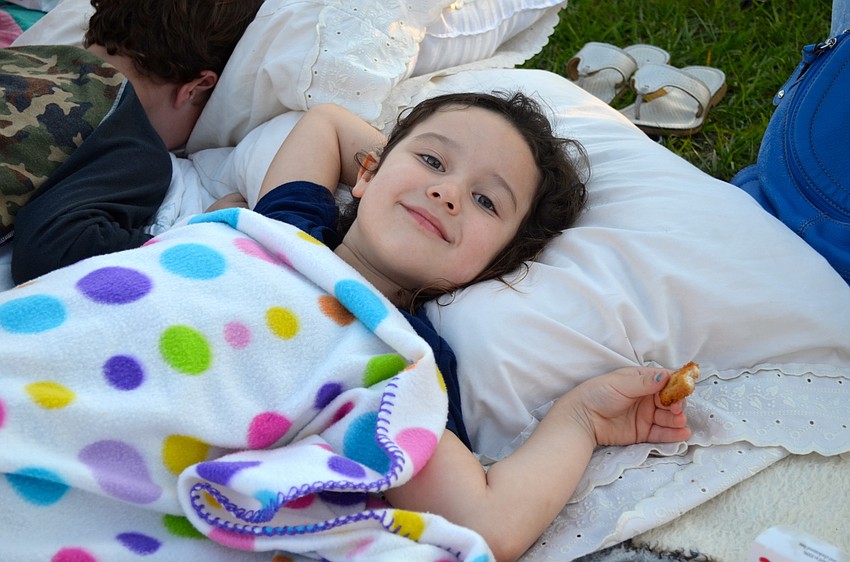 Four-year-old Kaylee Reid relaxes before the movie starts.
