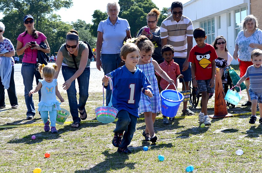 Children run to gather Easter eggs.
