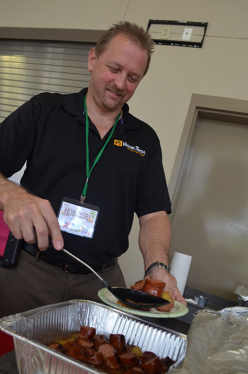 Jeff Hendershott passes out Hawaiian kielbasa.