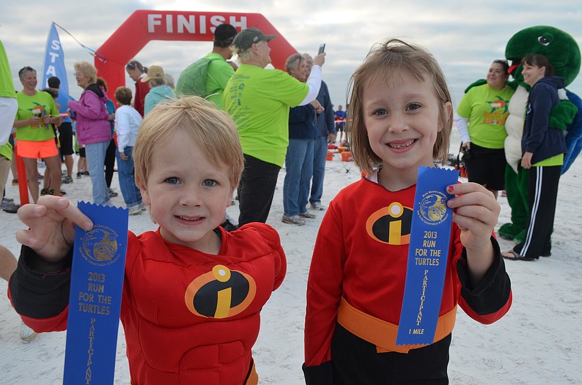 Henry Kepler and his sister Tasman show off their ribbons after the run.