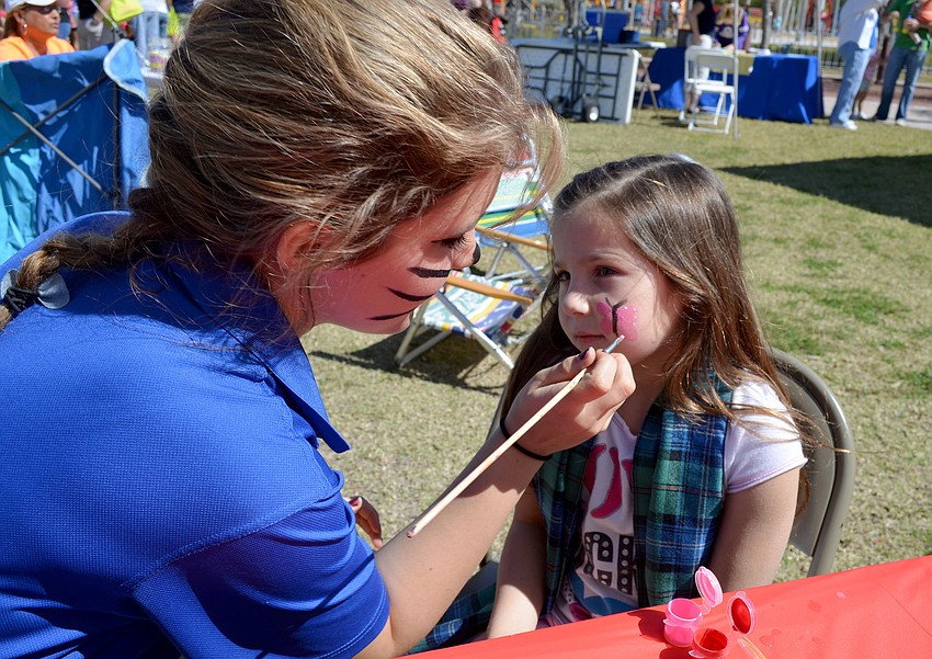 Mackenzie Heise gets her face painted.