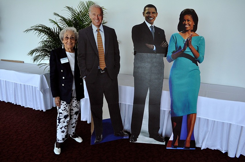 Lee Cafiero poses with cut-outs of vice president Joe Biden, president Barack Obama and first lady Michelle Obama.