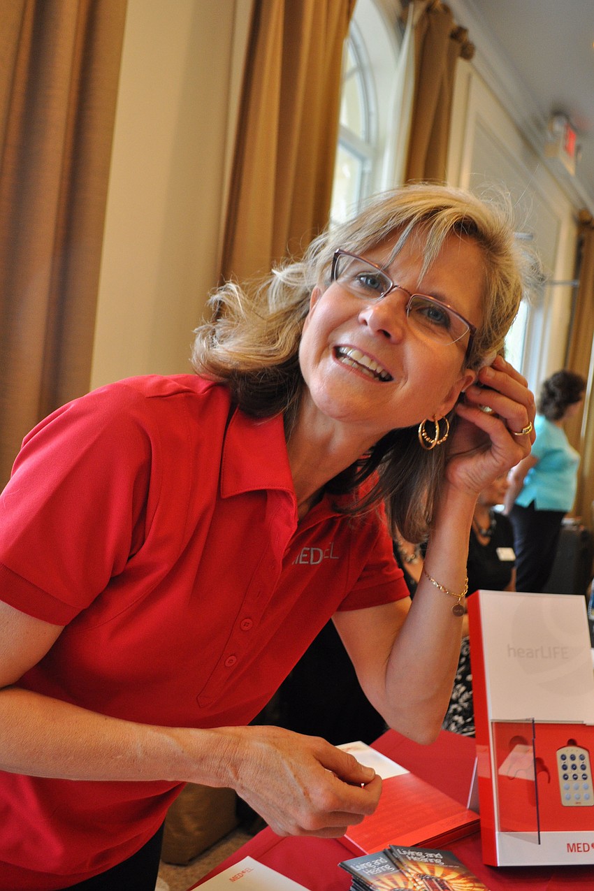 Virgi Mills shows off a new cochlear implant wearing option called Rondo. Med-El makes the product.