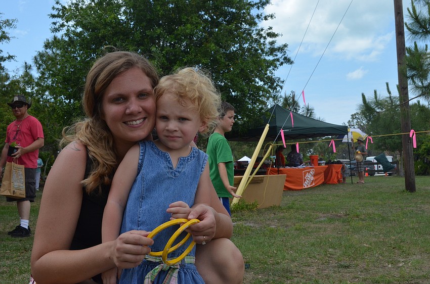Bre Rose tosses rings with her daughter Jolene in the Kid Village.