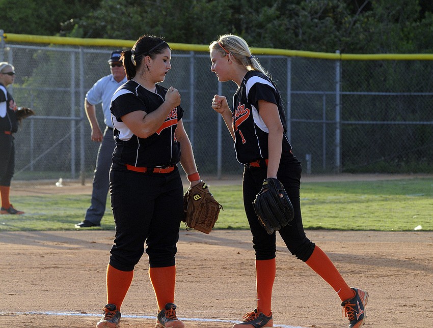 Sarasota pitcher Clarissa Lynch and second baseman Avery Miller pump one another up before the start of the bottom of the first inning.