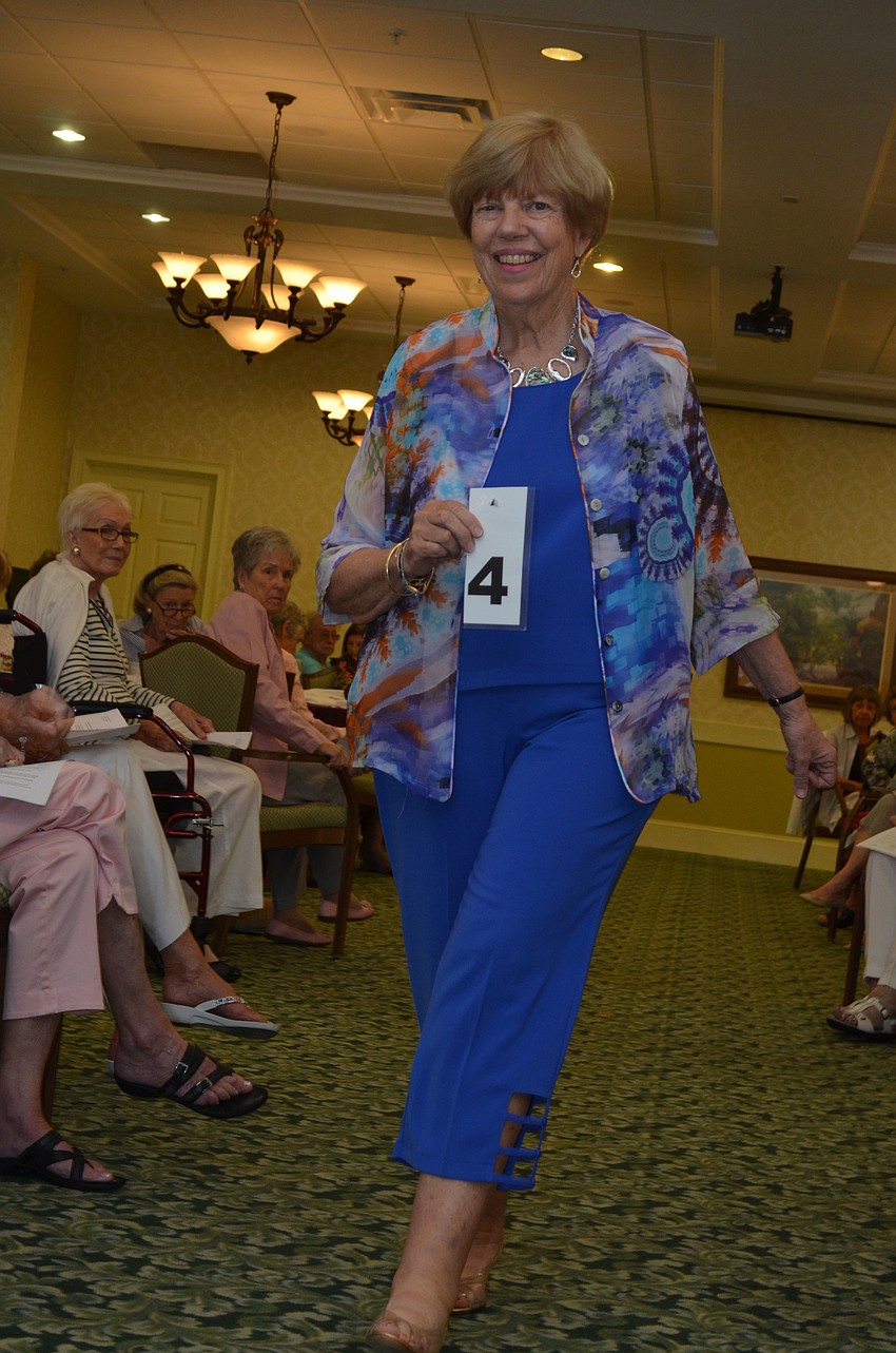 Judy White models Sea Suns blue aqua and orange print sheer mandarin shirt.