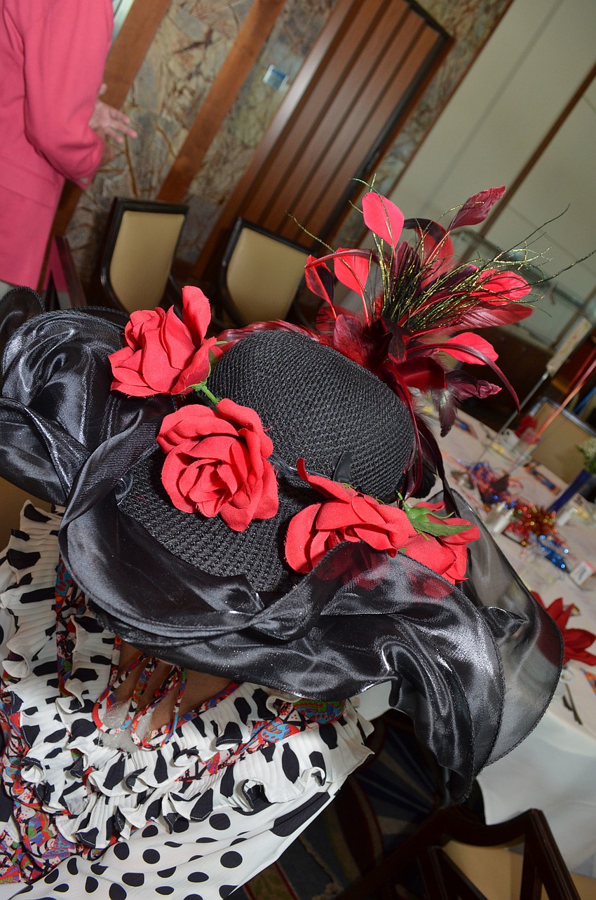 Betty Pawlowitz added red roses onto her hat to match the Run for the Roses Fundraise part of the 139th Kentucky Derby.