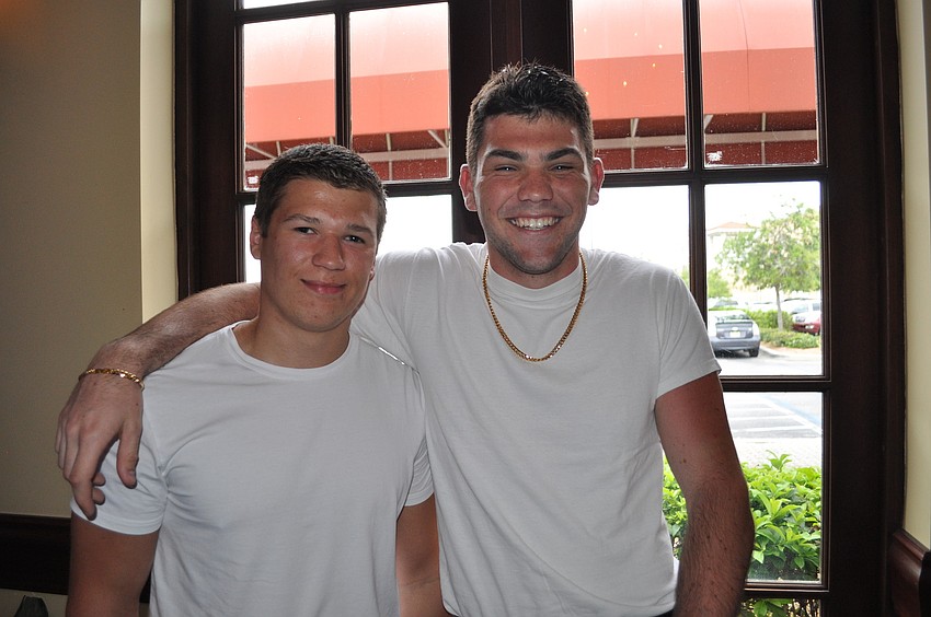 Lukas Labansuskas and Greg Ratzel work out at the YMCA.