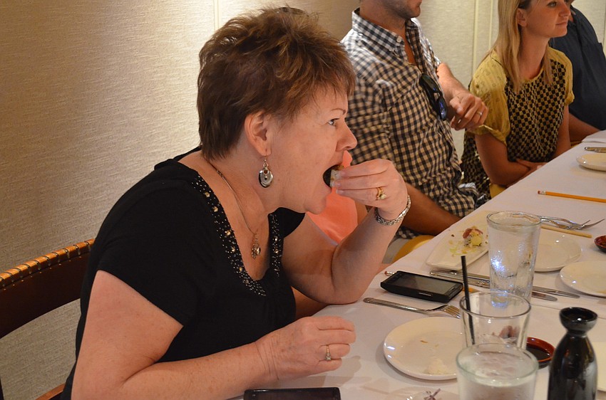 Tricia Bolds tastes eel for the first time â€” she says, â€œItâ€™s not bad.â€