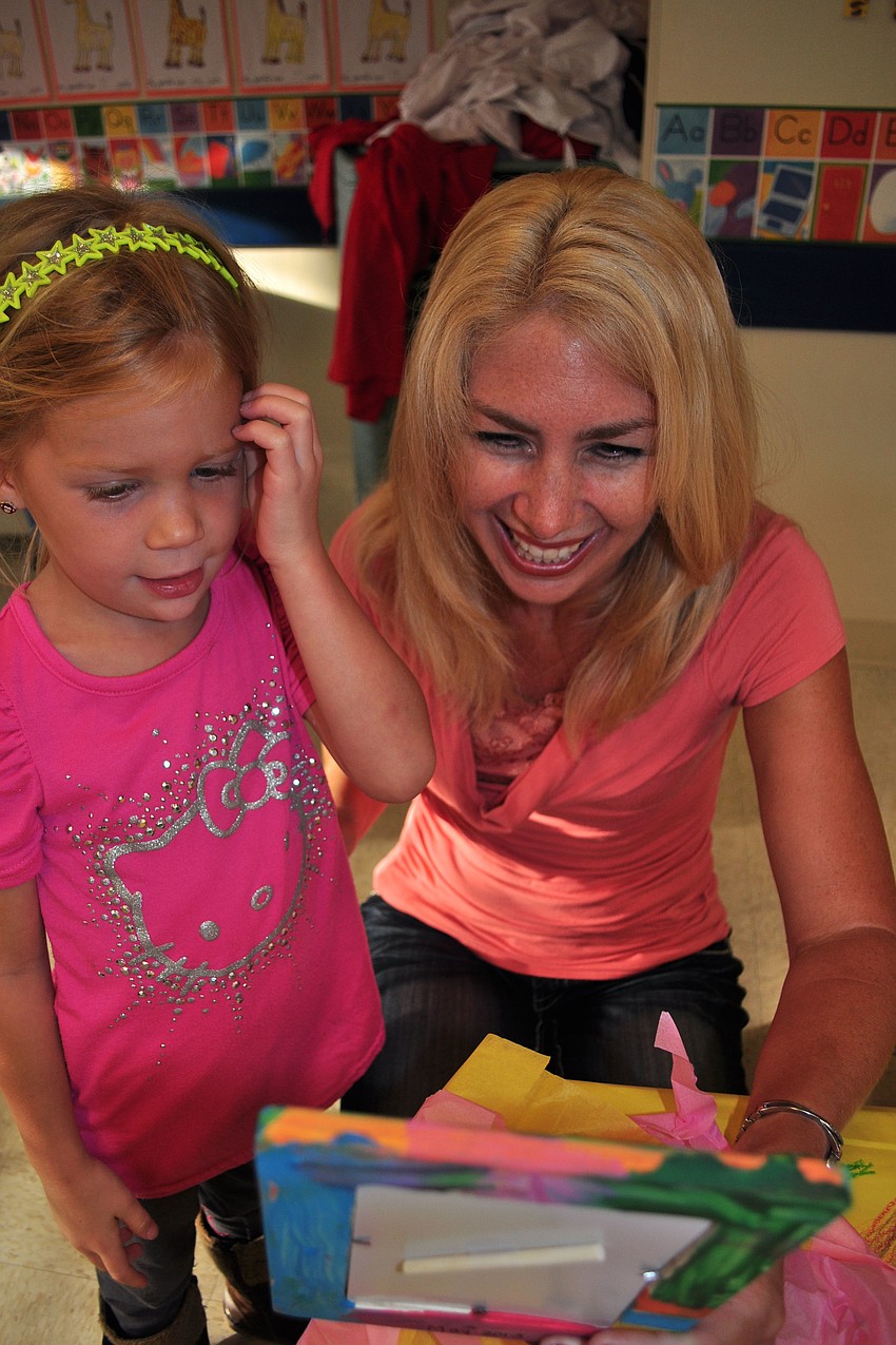 Hanna Hornung gives her mother, Michelle, a picture frame she made.