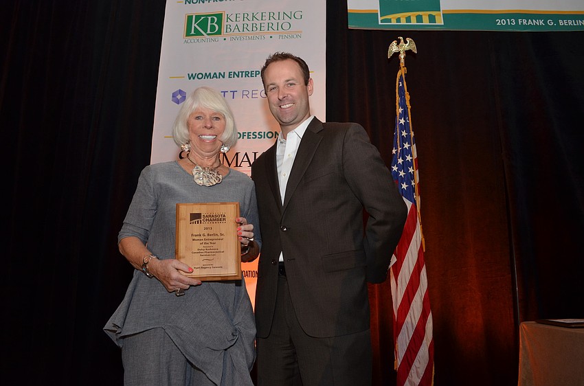 Chris Levine of the Hyatt Regency Sarasota presents Dulcy Kushmore with the Woman Entrepreneur of the Year Award.